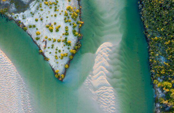 an aerial view of a river and a beach