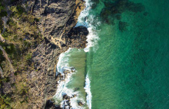 an aerial view of a body of water next to a cliff